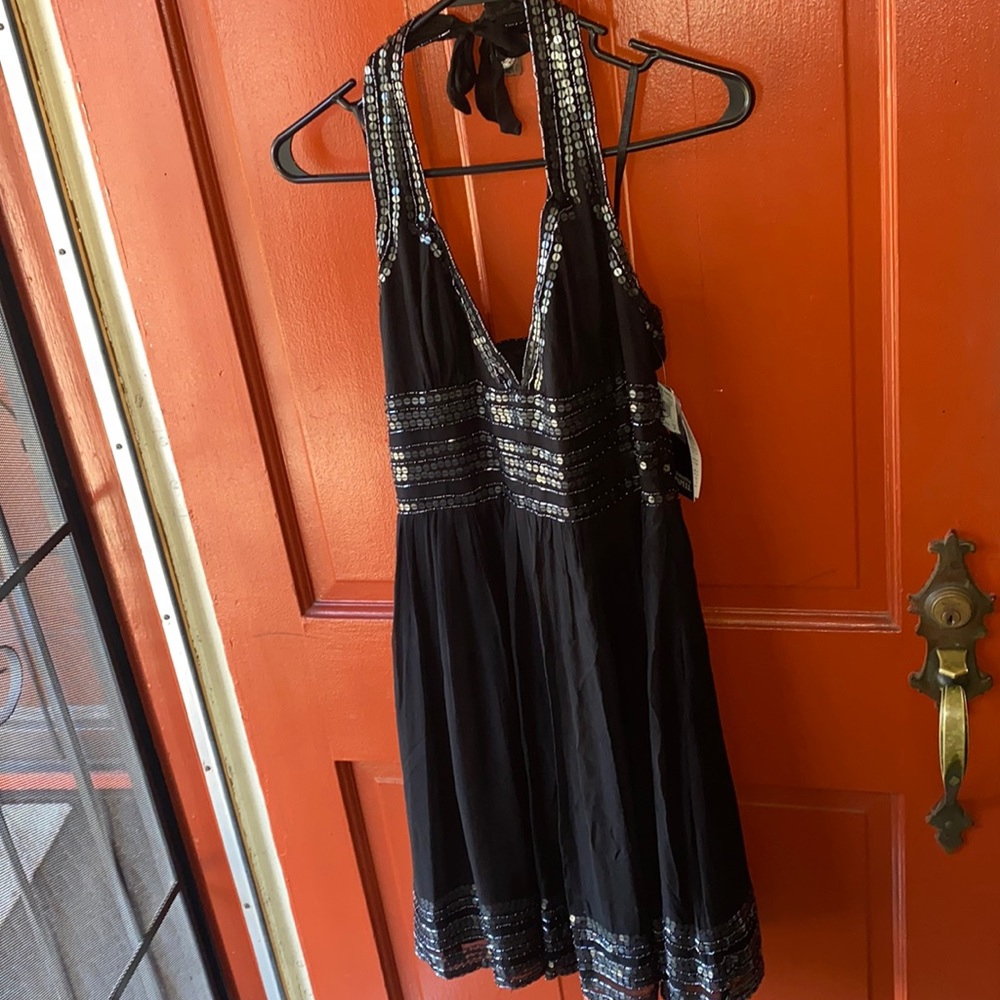 Black sequin short halter dress.
